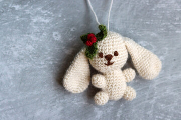Crochet amigurumi Christmas toy. Close up photo of hand made  staffed doll. Christmas decoration ideas. 