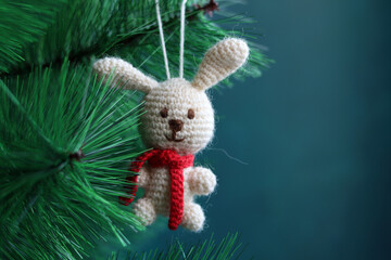 Fototapeta premium White crochet bunny close up photo. Handmade Christmas gift. Amigurumi animal pattern. 