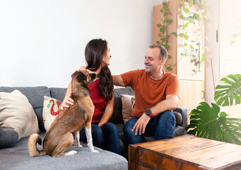 happy couple at home with the dog