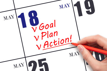 Hand writing text GOAL PLAN ACTION on calendar date May 18. Motivation for a new day. Business...