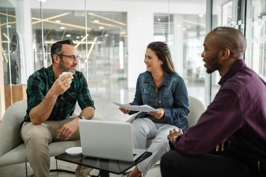 Casual meeting of smiling diverse business team