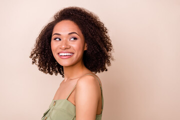 Profile side view portrait of pretty sweet cute lady hairdo haircut beaming shiny smile look empty space isolated on beige color background