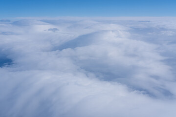 Background of a pink purple heavenly sky with fluffy dense clouds, top view from an airplane. Sky Gradient. Can be used as advertising background, overlay. Travel concept.