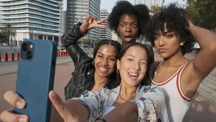 Transgender woman and friends grimacing and joking while making selfie