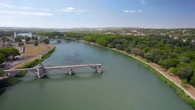 The drone aerial footage of Pont Saint Benezet bridge and Rhone river in Avignon. Avignon is a city on the Rhone river in southern France. The Pont Saint-B&eacute;n&eacute;zet also known as the Pont d'Avignon.