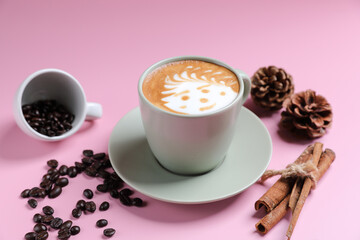 hot cappuccino with latte art isolated in pink background