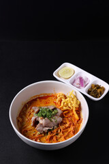 Khao Soi Thai Curry soup isolated in black background
