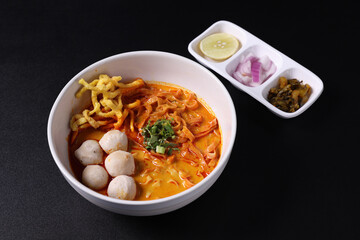 Khao Soi Thai Curry soup isolated in black background