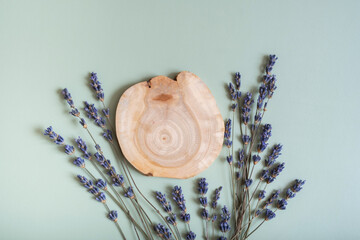 Wooden slice as podium or pedestal top view, flat lay with lavender flowers. Podium or pedestal...
