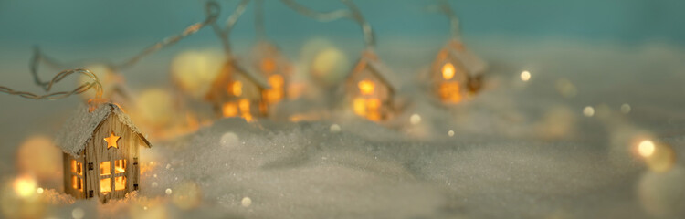 Abstract Christmas Winter Panorama with Wooden Houses Christmas String Lights in Cold Snow...