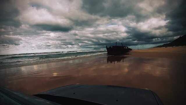 4WD - driving on the wet beach to a shipwreck (SS Maheno) on Fraser Island, julia patt, earth and more, Queensland, Australia during a storm