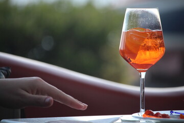 Spritz aperitif at the bar. Glass with ice.