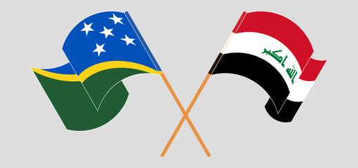 Crossed and waving flags of Solomon Islands and Iraq