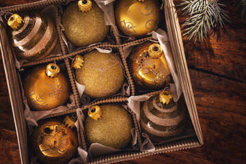 Christmas gold ornaments on the wooden background