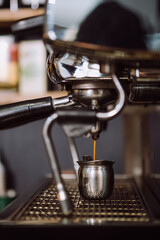 Close up of making hot coffee by coffee machine into cup. Beverage drink for breakfast. Crema Espresso perfect shot from coffee maker machine. Selective focus