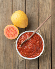 Goiabada, traditional brazilian creamy guava sweet with fruits over wooden table