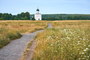 Fototapeta na wymiar Path in the meadow to Church of the Intercession on the Nerl