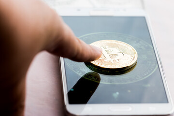 Crypto currency concept. Bitcoin digital currency on screen smartphone. Cryptocurrency investor analyst using mobile phone apps for analytics crypto financial market