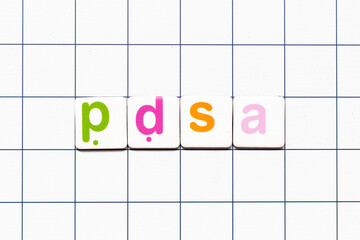 Colorful tile letter in word PDSA (Abbreviation of plan do study act) on white grid background
