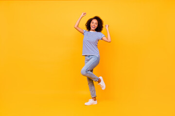 Full size photo of excited delighted person raise fists celebrate achievement isolated on yellow...