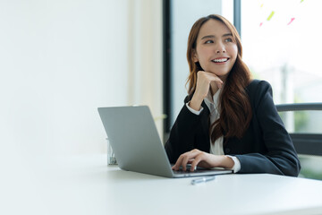 Businesswoman working on a laptop for business information in office.