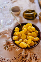 Boiled young potato and pickles in plates on table