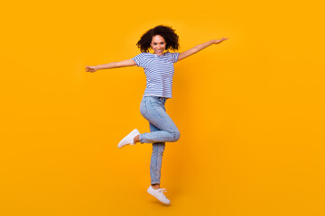 Fototapeta na wymiar Full body photo of energetic cheerful girl jump have good mood rejoice isolated on yellow color background