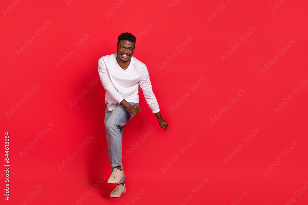Wall mural Full length photo of overjoyed laughing carefree male dancing flirting with girlfriend isolated on red color background - Wall murals