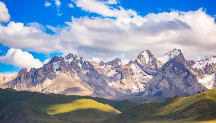 Beautiful nature of rocky mountains and peaks with glaciers. Unusual landscape of nature. Rocks on the background of the sky with clouds. Bad weather cyclone, rainy season, foggy day.