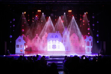 The stage of the theater illuminated by spotlights from the auditorium