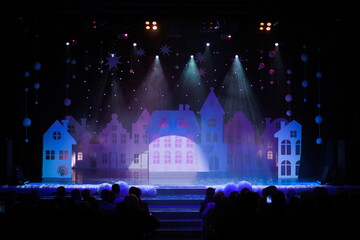 The stage of the theater illuminated by spotlights from the auditorium