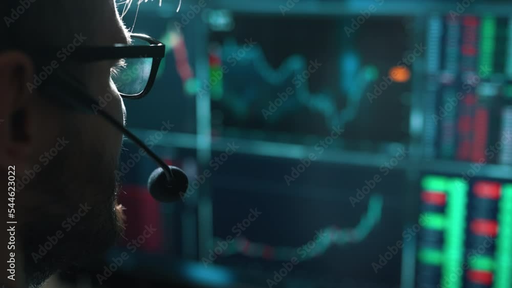 Poster trader is working with multiple computer screens with charts and data analysis and stock broker trad