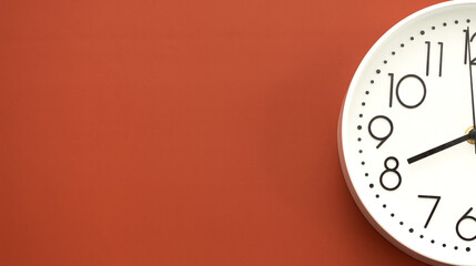Clock on a red background, the concept of time management, time planning. Web banner, free space.