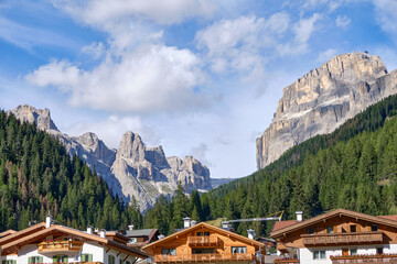View of city of Canazei. Its a comune (municipality) in Trentino in the northern Italian region Trentino-Alto Adige/Sudtirol. - obrazy, fototapety, plakaty