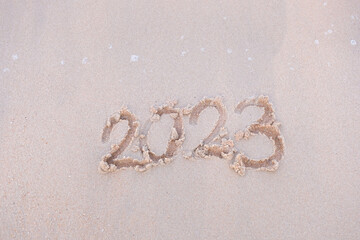 2023 happy New Year coming concept. White waves are lapping towards the shore
