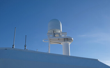 VSAT terminal, satellite internet connection, navigation equipment installed on the ship's superstructure. Telecommunications and Navigation equipment on the upper decks of a modern cruise ship.