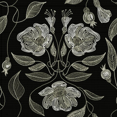 Embroidered flowers and leaves ornament on a dark background.