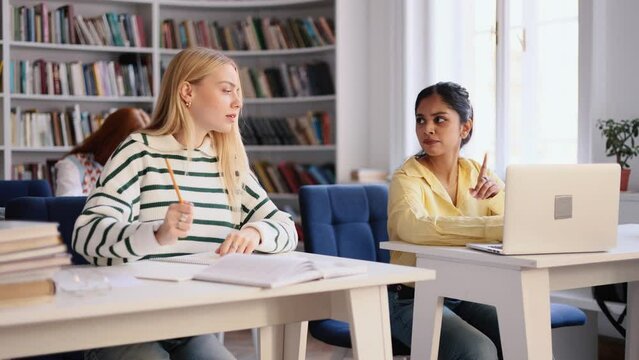 Confused girl try to writes off the test work from a classmate, but everybody hide their tests. Сunning student tries to cheat on exams in multiethnic group.