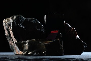 Composition of micro sd cards and dark stones. close-up