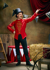 Vintage portrait of male retro circus entertainer expresses rejoice and announces start of show...