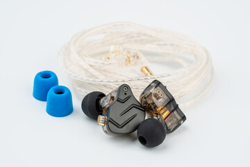In ear monitor on a tablature background. Custom in-ear monitors with black plates. Custom in ear...