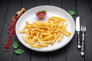 Appetizing side dish - French fries with ketchup in a white plate