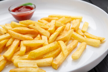 Appetizing side dish - French fries with ketchup in a white plate