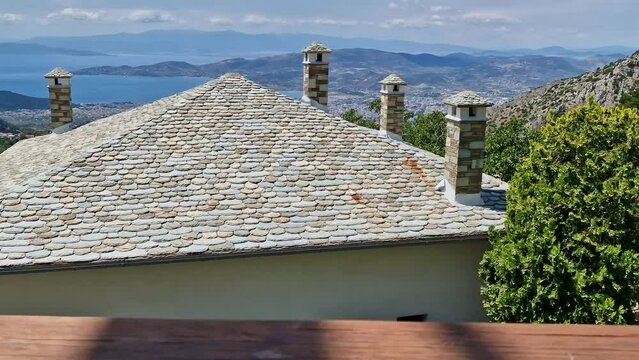 View of Volos seaside city from the traditional greek village of Makrinitsa on Pelion mountain in central Greece on a summer day
