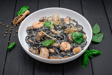 Plate of black spaghetti with prawn, mussels