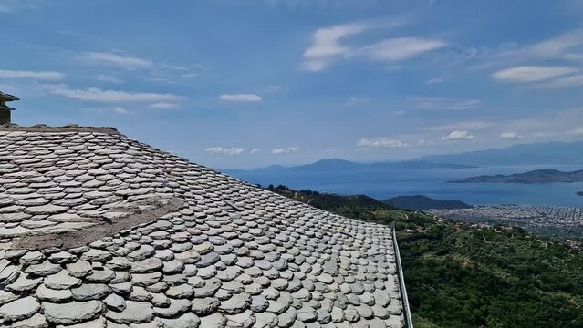 View of Volos seaside city from the traditional greek village of Makrinitsa on Pelion mountain in central Greece on a summer day
