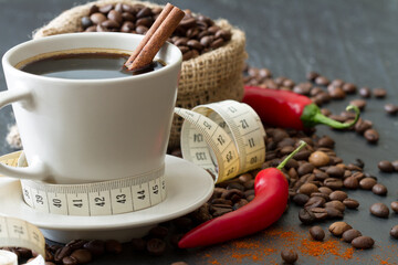 Spicy coffee with chili pepper and cinnamon with tape measure, natural way to support weight loss...