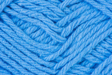 Blue yarn thread close-up as background 