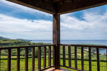 Wood balcony and the tea plantation in the Background. Tea Plantation of Porto Formoso on the north coast of the island of Sao Miguel in the Azores archipelago, Portugal.