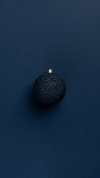 Christmas Card With Blue Glitter Ball On Dark Blue Background